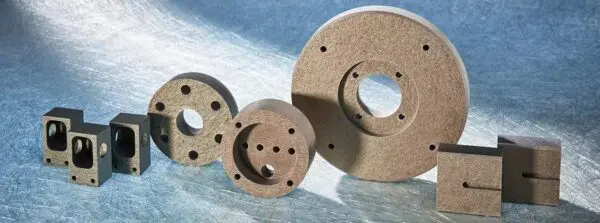 A group of three wooden discs with holes in them.