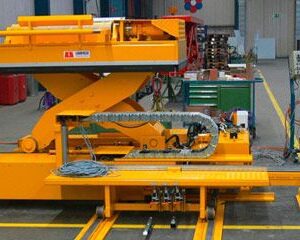 A yellow scissor lift in an industrial setting.