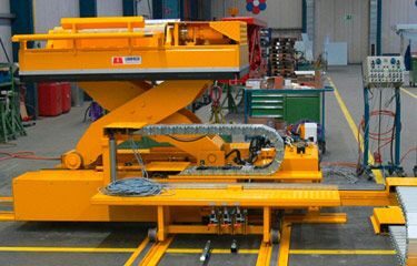 A yellow scissor lift in an industrial setting.