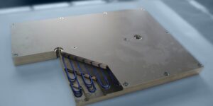 A metal plate with blue wire attached to it.